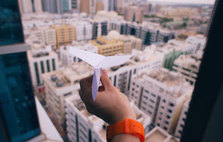 paper plane over a city