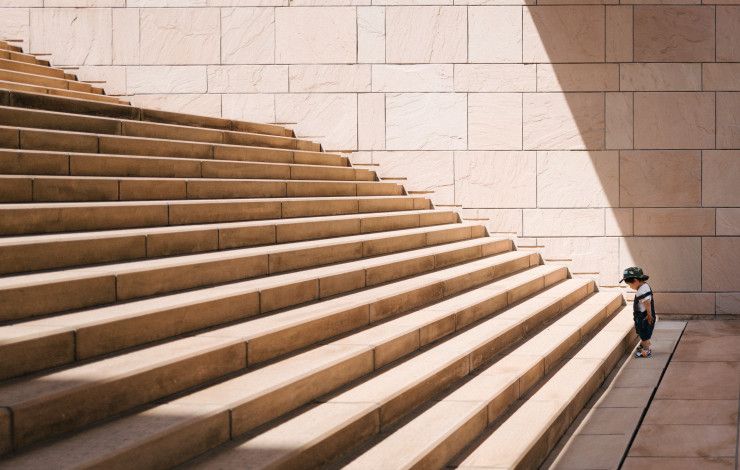 kid looking at large staircase