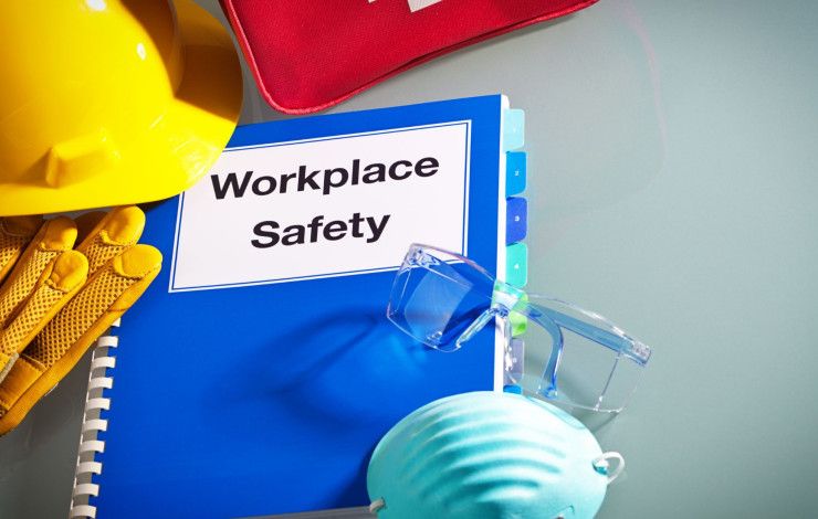 A book with the words 'Workplace Safety' with a hard hat and glasses