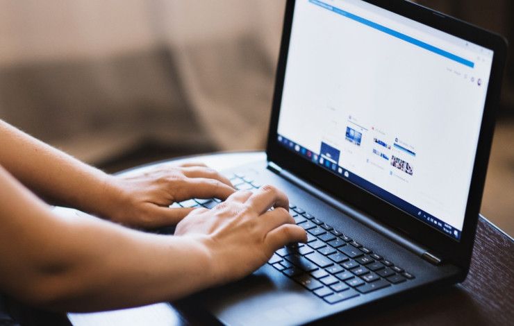 a person typing on a laptop