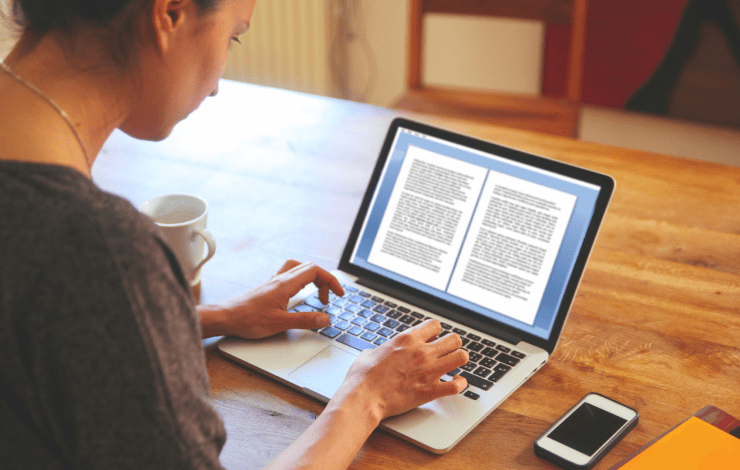 a person writing on a laptop