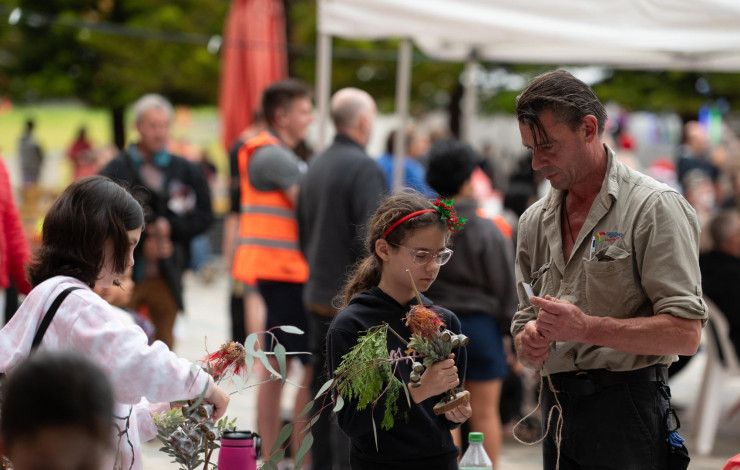 Ranger with a child at Carols in Harmony Square