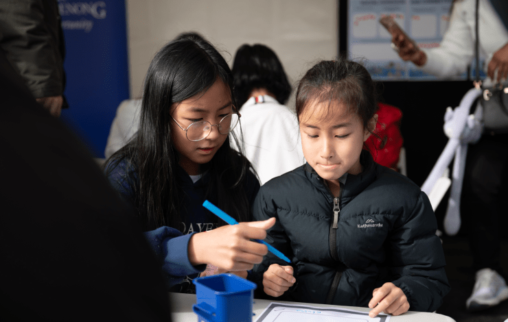 Children sitting at a table drawing