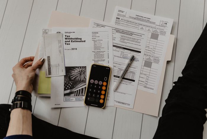 forms, calculator and paperwork on a table