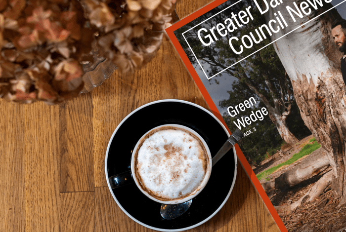 Greater Dandenong Council News on a table with coffee