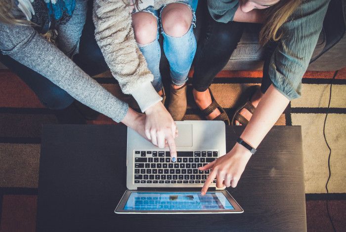 group pointing to a laptop