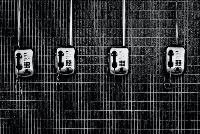Four pay telephones on a wall