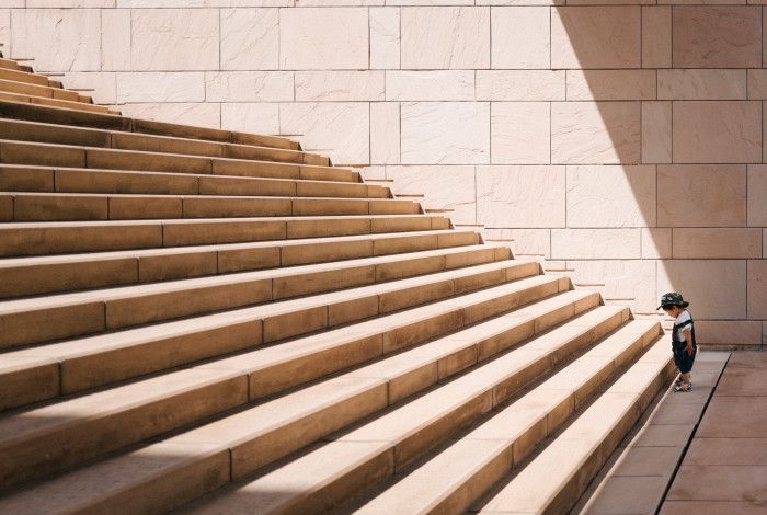 kid looking at large staircase