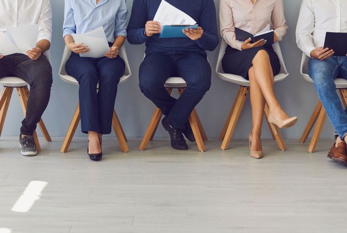 people sitting in a row on chairs