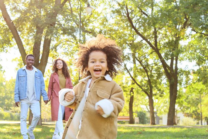 Family photo with mum, dad and child in a park