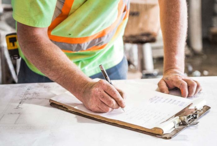 A person writing on a form