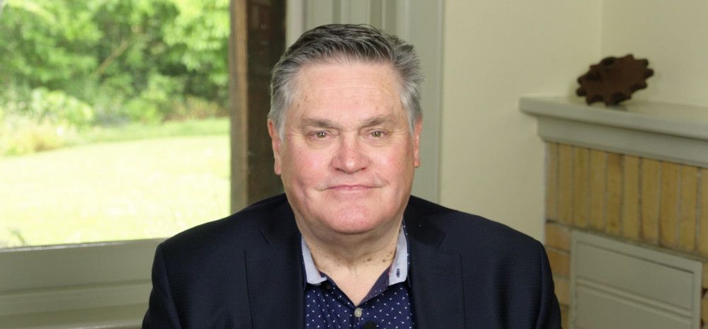 John Bennie sitting in front of window