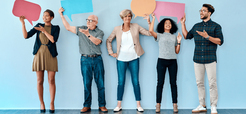 people standing holding speech bubbles