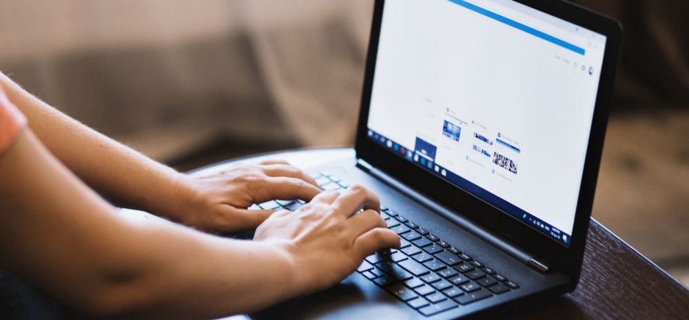 a person typing on a laptop