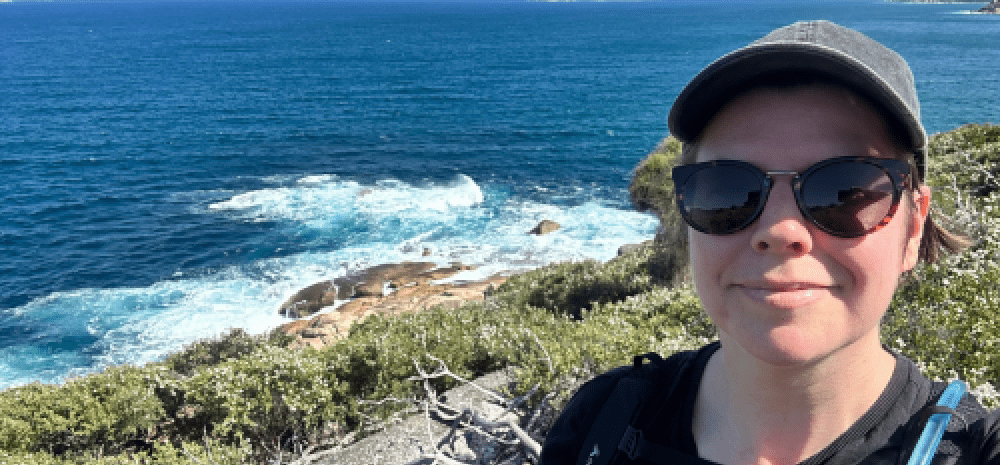 a person on a cliff smiling