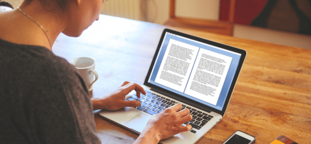 a person writing on a laptop