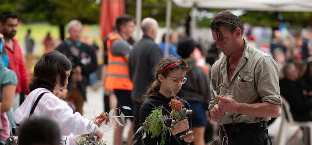 Ranger with a child at Carols in Harmony Square