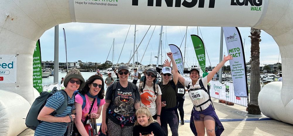 a group of people standing at a finish line