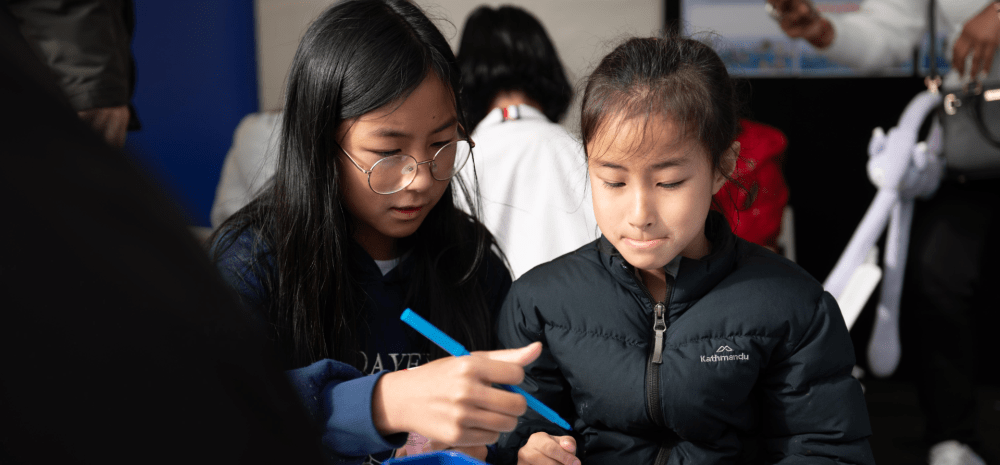 Children sitting at a table drawing