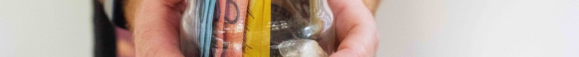 Man holding a jar of money