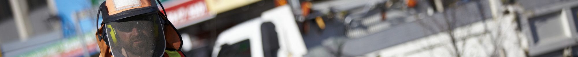 Outdoor staff member holding a whipper snipper