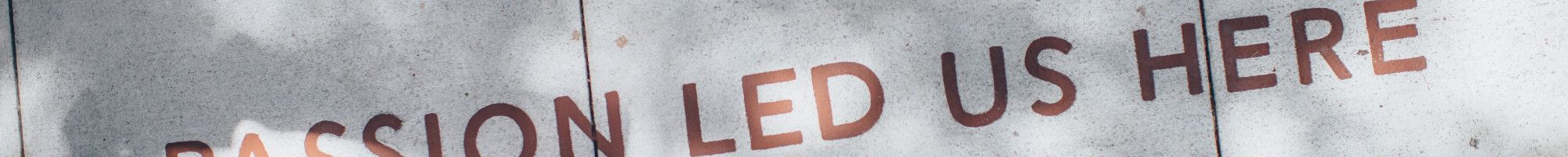 pavement with 'passion lead us here' embedded into it