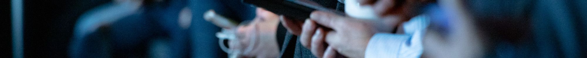 members of the media on mobile phones