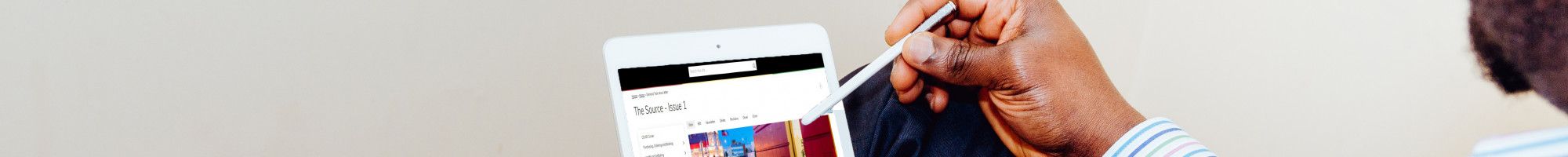 Man reading Source Enews on tablet