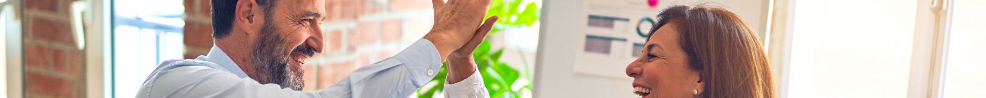 hi five workers with laptops