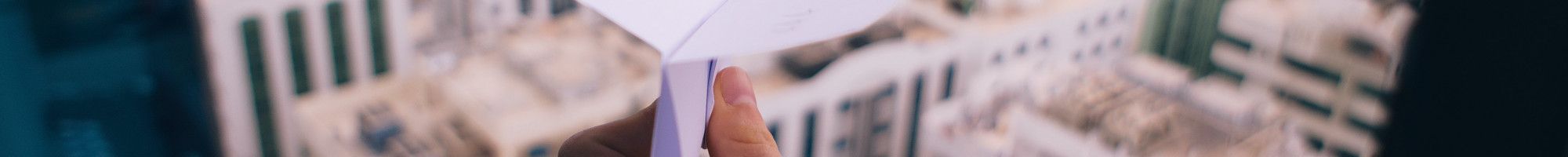 paper plane over a city