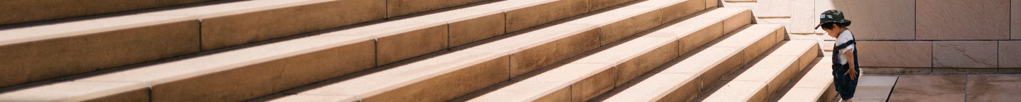 kid looking at large staircase