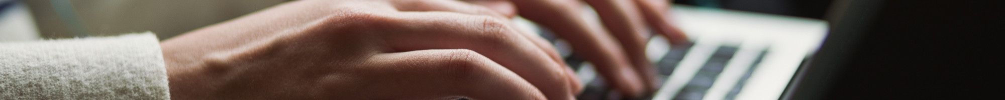 hands on laptop keyboard