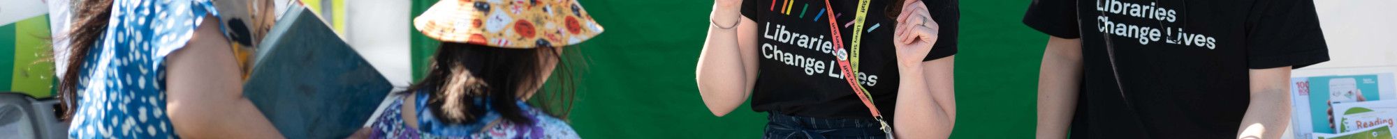 library staff chatting to a family at a festival stall