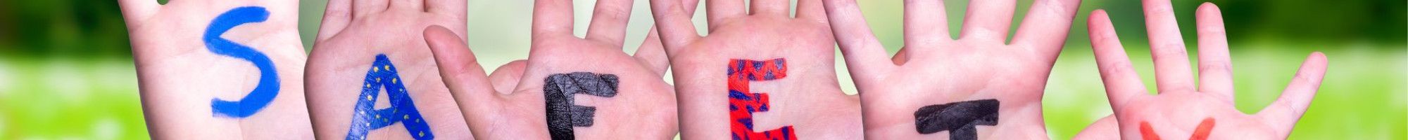 Children's hands with letters painted spelling safety