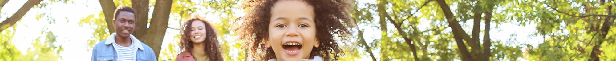 Family photo with mum, dad and child in a park