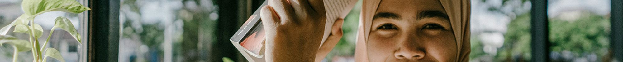 A teenager looking at her book