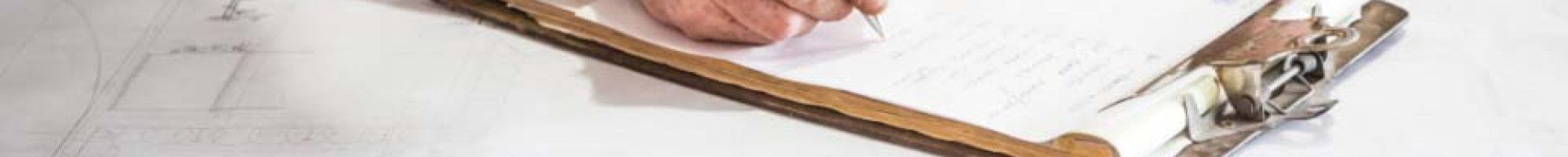 A person writing on a form