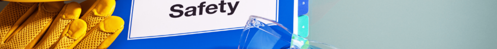 A book with the words 'Workplace Safety' with a hard hat and glasses