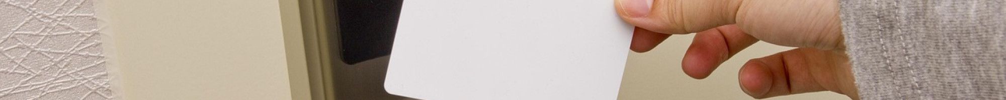 A person using a swipe card on a door