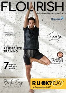 the cover of Flourish magazine pictures a person doing yoga