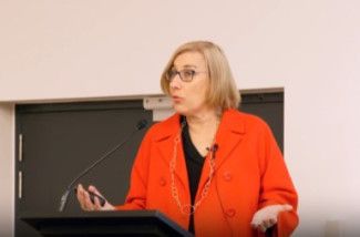 Jacqui Weatherill standing at a podium speaking