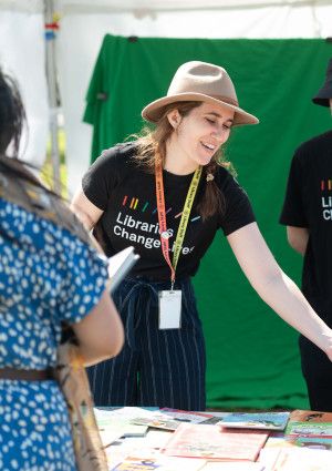library staff chatting to a family at a festival stall