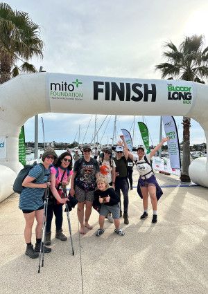 a group of people standing at a finish line
